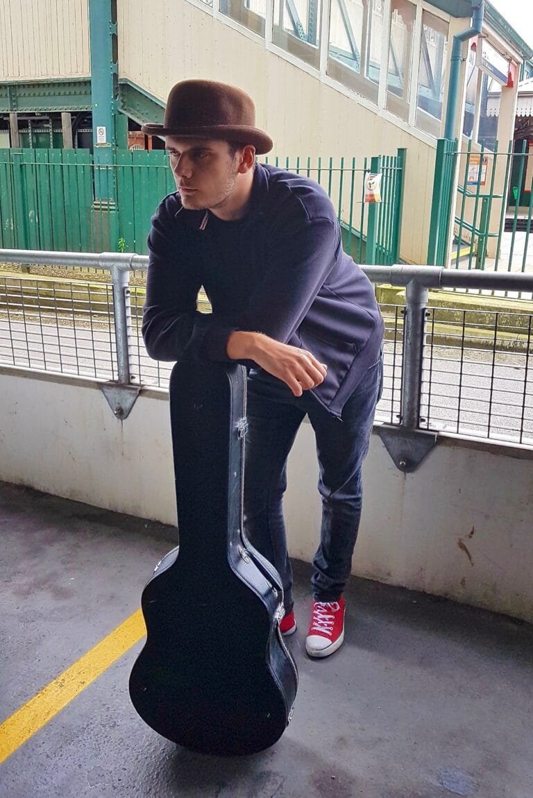 Jack-Donald-nottingham-guitarist-leaning-on-acoustic-case